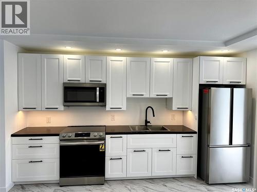 117 U Avenue S, Saskatoon, SK - Indoor Photo Showing Kitchen With Double Sink