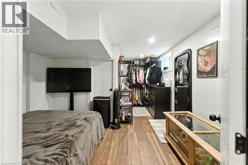 Primary Bedroom with light wood-style flooring and an open-concept closet area - 90 Toby Crescent Unit# Lower, Hamilton, ON - Indoor