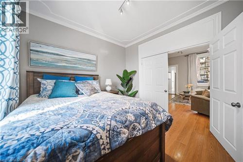 Main floor bedroom. Looking from Bedroom into Living Room with Kitchen & Bath Beyond - 107 Queen Street S, Hamilton, ON - Indoor Photo Showing Bedroom