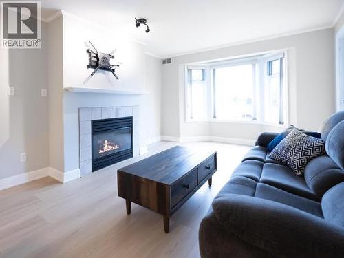 202-4685 Joyce Ave, Powell River, BC - Indoor Photo Showing Living Room With Fireplace