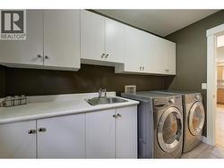 Laundry room with built in cabinetry and sink - 