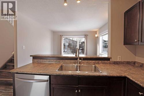 Main Floor - Kitchen looking into living room - 322 17 Street E, Brooks, AB - Indoor Photo Showing Kitchen With Double Sink