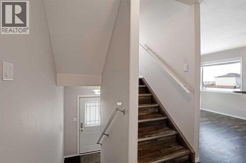 Main Floor Landing - Stairs to Upper Level - 322 17 Street E, Brooks, AB - Indoor Photo Showing Other Room
