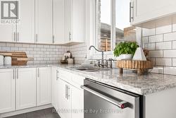 Upgraded faucet, subway tile backsplash - 