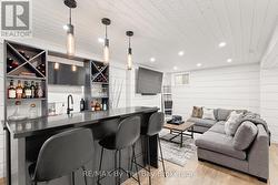 Modern built-in wet bar with 2-sided  seating - 