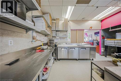 Kitchen with stainless steel countertops, a paneled ceiling, and open shelves - 223 Louisa Street, Kitchener, ON 
