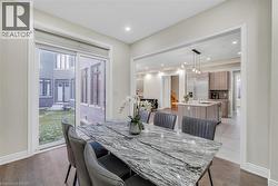 Dining room featuring dark wood finished floors and recessed lighting - 