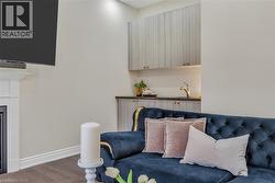 Living area featuring baseboards and wood finished floors - 