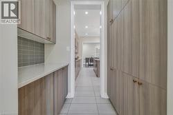 Hallway with light tile patterned flooring and recessed lighting - 