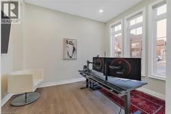 Office space with baseboards and wood finished floors - 