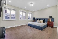 Bedroom with wood finished floors and recessed lighting - 