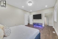 Bedroom with dark wood-type flooring and recessed lighting - 