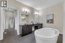 Full bathroom with double vanity and a freestanding tub - 