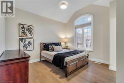 Bedroom featuring lofted ceiling and wood finished floors - 