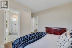 Bedroom with light wood-style flooring and baseboards - 