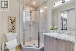 Bathroom featuring vanity, a shower stall, and light tile patterned floors - 