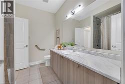 Bathroom with vanity and light tile patterned floors - 