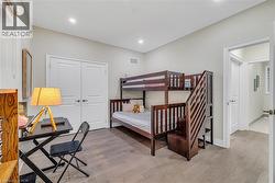Bedroom featuring light wood-style floors and a closet - 