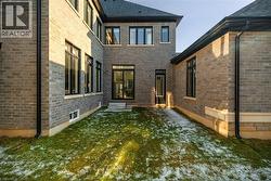 Rear view of property with brick siding and a patio - 