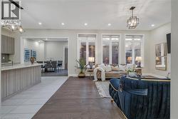 Living area with light wood-style flooring and recessed lighting - 