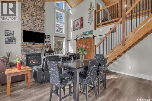 102 Moore Drive, Christopher Lake, SK - Indoor Photo Showing Dining Room With Fireplace