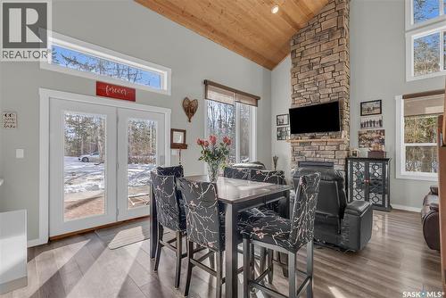 102 Moore Drive, Christopher Lake, SK - Indoor Photo Showing Dining Room With Fireplace