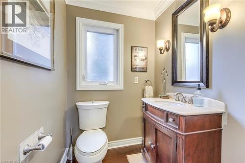 Bathroom with vanity, crown molding, and dark wood-type flooring - 4220 Millcroft Park Drive, Burlington, ON - Indoor Photo Showing Bathroom