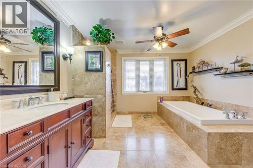 Full bathroom featuring ceiling fan, ornamental molding, vanity, a walk in shower, and light tile patterned flooring - 4220 Millcroft Park Drive, Burlington, ON - Indoor Photo Showing Bathroom