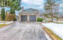 View of property exterior featuring asphalt driveway, a chimney, brick siding, a shingled roof, and a garage - 4220 Millcroft Park Drive, Burlington, ON  - Outdoor 