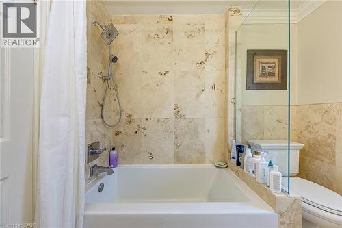 Bathroom featuring shower / tub combo and tile walls - 4220 Millcroft Park Drive, Burlington, ON - Indoor Photo Showing Bathroom