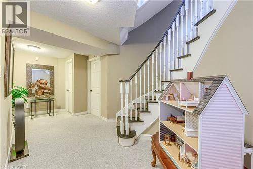 Staircase with carpet flooring and a textured ceiling - 4220 Millcroft Park Drive, Burlington, ON - Indoor Photo Showing Other Room
