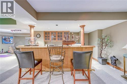 Indoor bar featuring light carpet, recessed lighting, light countertops, and wood finish cabinetry - 4220 Millcroft Park Drive, Burlington, ON - Indoor Photo Showing Dining Room