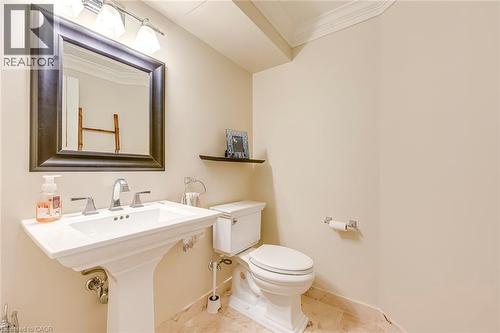Half bathroom with ornamental molding and toilet - 4220 Millcroft Park Drive, Burlington, ON - Indoor Photo Showing Bathroom