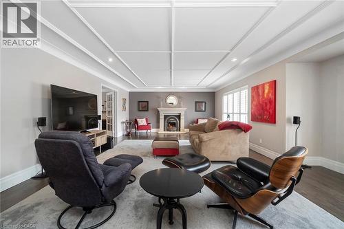Living room with gas fireplace and access into oversized office - 18 Stonegate Drive, Hamilton, ON - Indoor Photo Showing Other Room