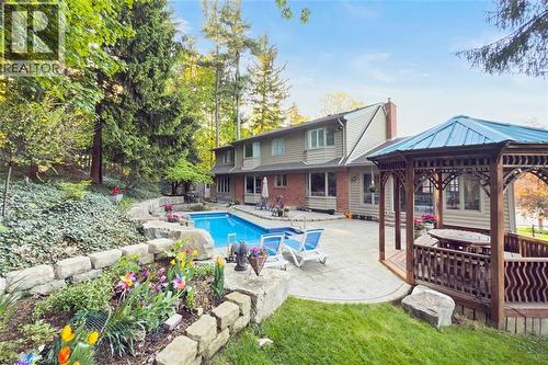 Garden and grass yard - 18 Stonegate Drive, Hamilton, ON - Outdoor With In Ground Pool