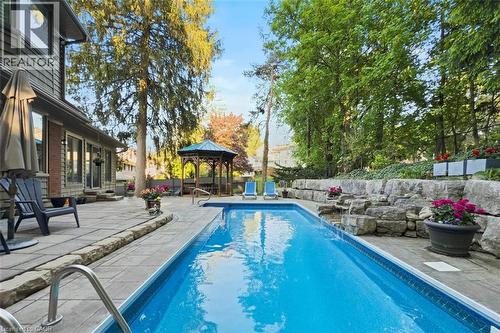 Pool with waterfall - 18 Stonegate Drive, Hamilton, ON - Outdoor With In Ground Pool