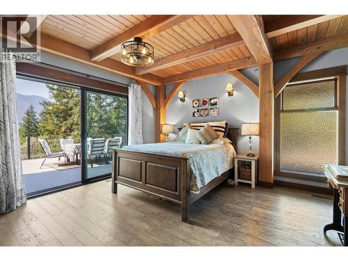 Main floor Primary Bedroom has 8 ft wide sliding doors to deck - 1403 Notch Hill Road, Sorrento, BC - Indoor Photo Showing Bedroom