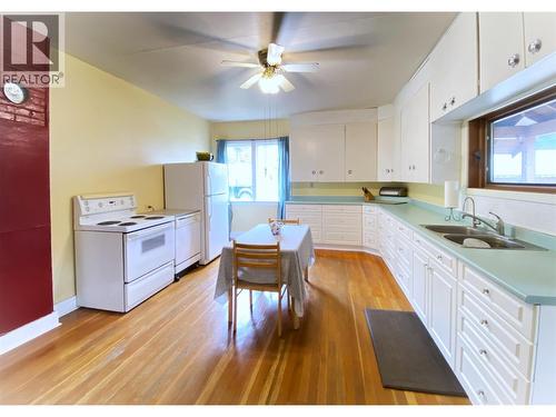 Kitchen with original hardwood floors - refinished in 2025 - 1403 Notch Hill Road, Sorrento, BC - Indoor Photo Showing Kitchen With Double Sink