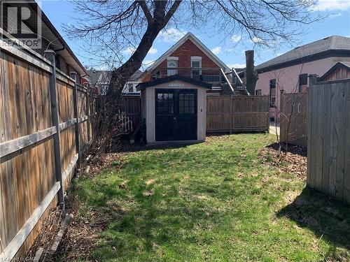 Fenced backyard with a shed - 405 Macnab Street N, Hamilton, ON - Outdoor