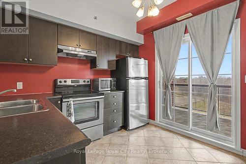 412 - 308 Watson Parkway N, Guelph (Grange Road), ON - Indoor Photo Showing Kitchen With Double Sink