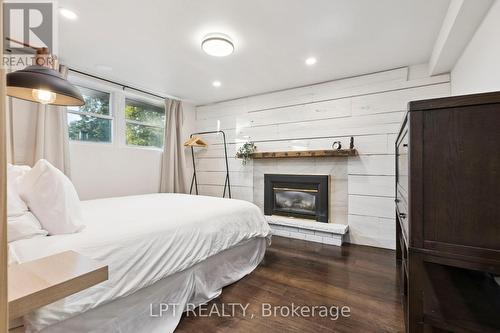 7429 Sideroad 20 Side Road, Mapleton, ON - Indoor Photo Showing Bedroom With Fireplace