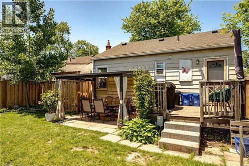 Expansive backyard featuring a manicured lawn, paved patio area, and a covered pergola - 364 Tragina Avenue N, Hamilton, ON - Outdoor With Deck Patio Veranda