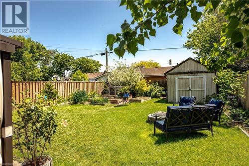 Expansive backyard featuring a manicured lawn, wood privacy fence, and mature landscaping - 364 Tragina Avenue N, Hamilton, ON - Outdoor