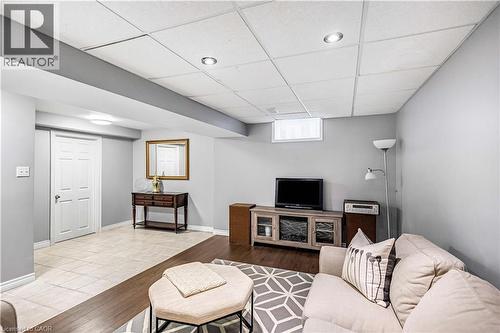 Living area with a paneled ceiling and wood finished floors - 65 Thistlemoor Drive, Caledonia, ON - Indoor Photo Showing Other Room