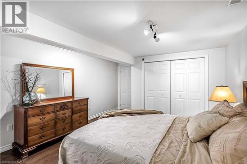 Bedroom featuring dark wood-type flooring, a closet, and track lighting - 65 Thistlemoor Drive, Caledonia, ON - Indoor Photo Showing Bedroom