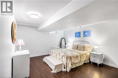 Bedroom with dark wood finished floors and baseboards - 65 Thistlemoor Drive, Caledonia, ON - Indoor Photo Showing Bedroom