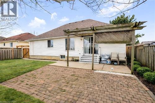 Rear view of property featuring a patio, a fenced backyard, entry steps, and roof with shingles - 65 Thistlemoor Drive, Caledonia, ON - Outdoor