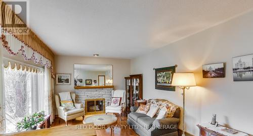 Living room with hardwood floors - 234 Manitoulin Drive, London East (East O), ON - Indoor Photo Showing Living Room With Fireplace