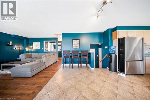 Living area featuring light tile patterned flooring and track lighting - 132 Blackburn Drive, Brantford, ON - Indoor