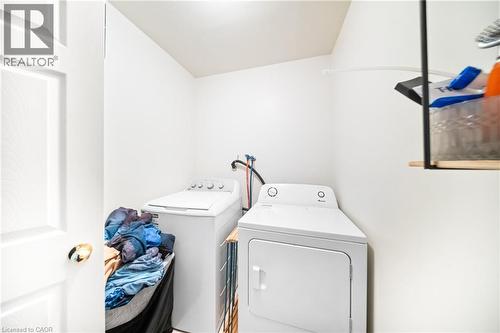 Washroom with washing machine and clothes dryer - 132 Blackburn Drive, Brantford, ON - Indoor Photo Showing Laundry Room